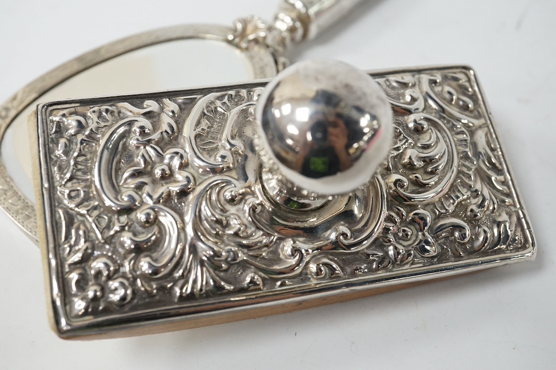 An early to mid 20th century continental white metal mounted combination compact and lipstick holder?, 14.2cm, together with an Edwardian repousse silver mounted blotter. Condition - poor to fair